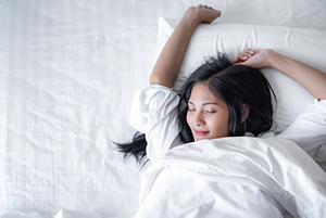  Woman sleeping comfortably in bed