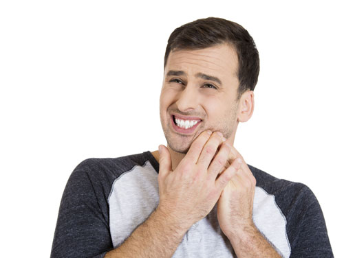 man holding face in pain because of burns