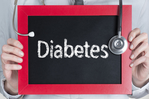 Dentist holding diabetes sign