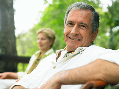 Old man and his wife in the background worried that he's going to have another stroke