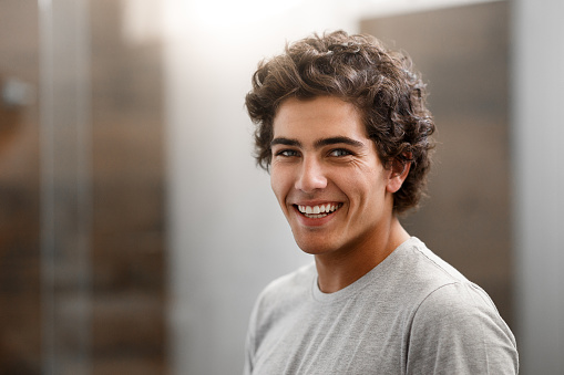 A smiling young person with straight teeth from ClearCorrect aligners