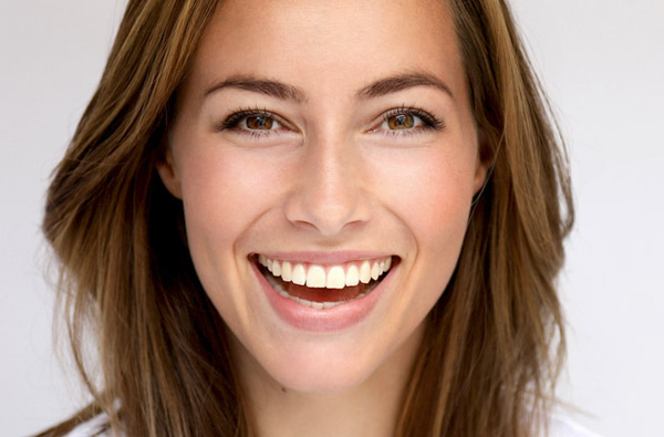 Beautiful woman smiling after receiving cosmetic dentistry treatment at Premier Dental